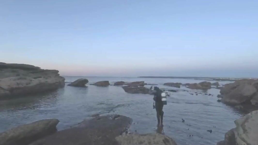 Diver entering the rocky Voodoo dive site at Kurnell in very calm seas